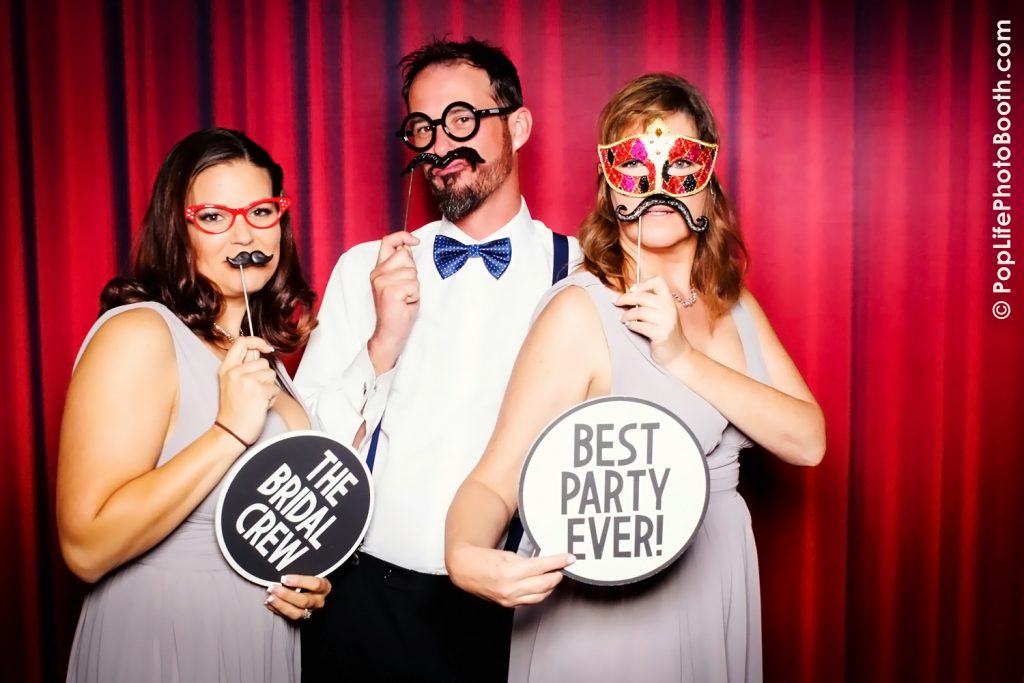 These three are having fun with our Photo Booth in Front of our Grand Red Backdrop