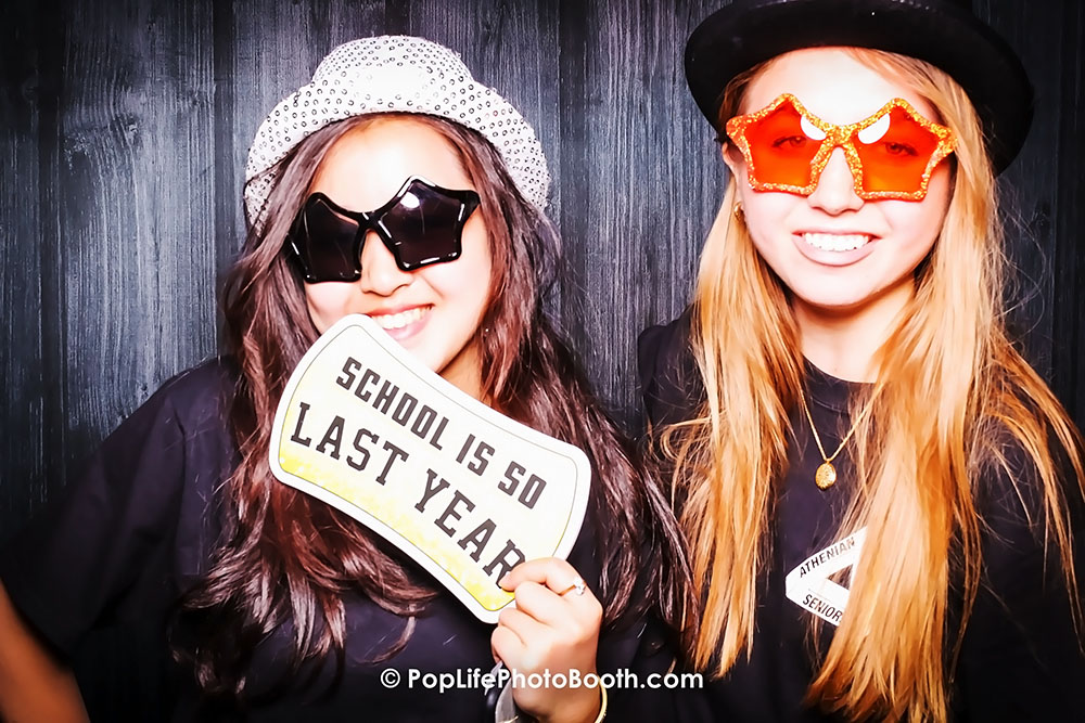 Two Students Holding a Photo Booth SIgn