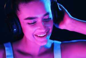 colorful lit woman smiling to high energy music