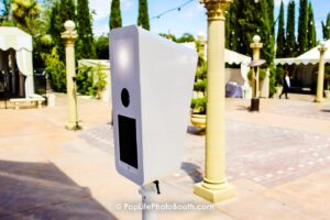 a compact white Pop Life Photo booth experience for weddings