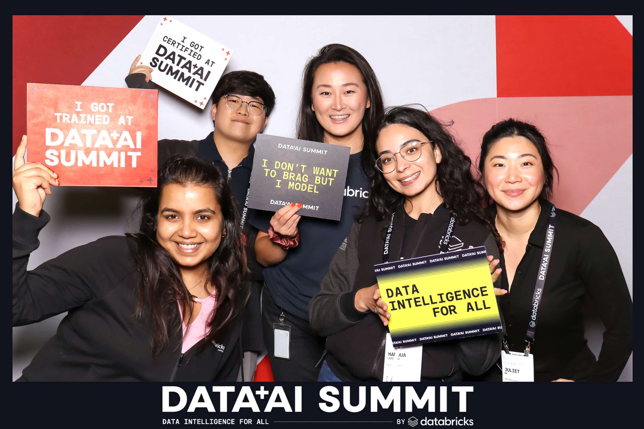 Team photo at the Data + AI Summit booth.