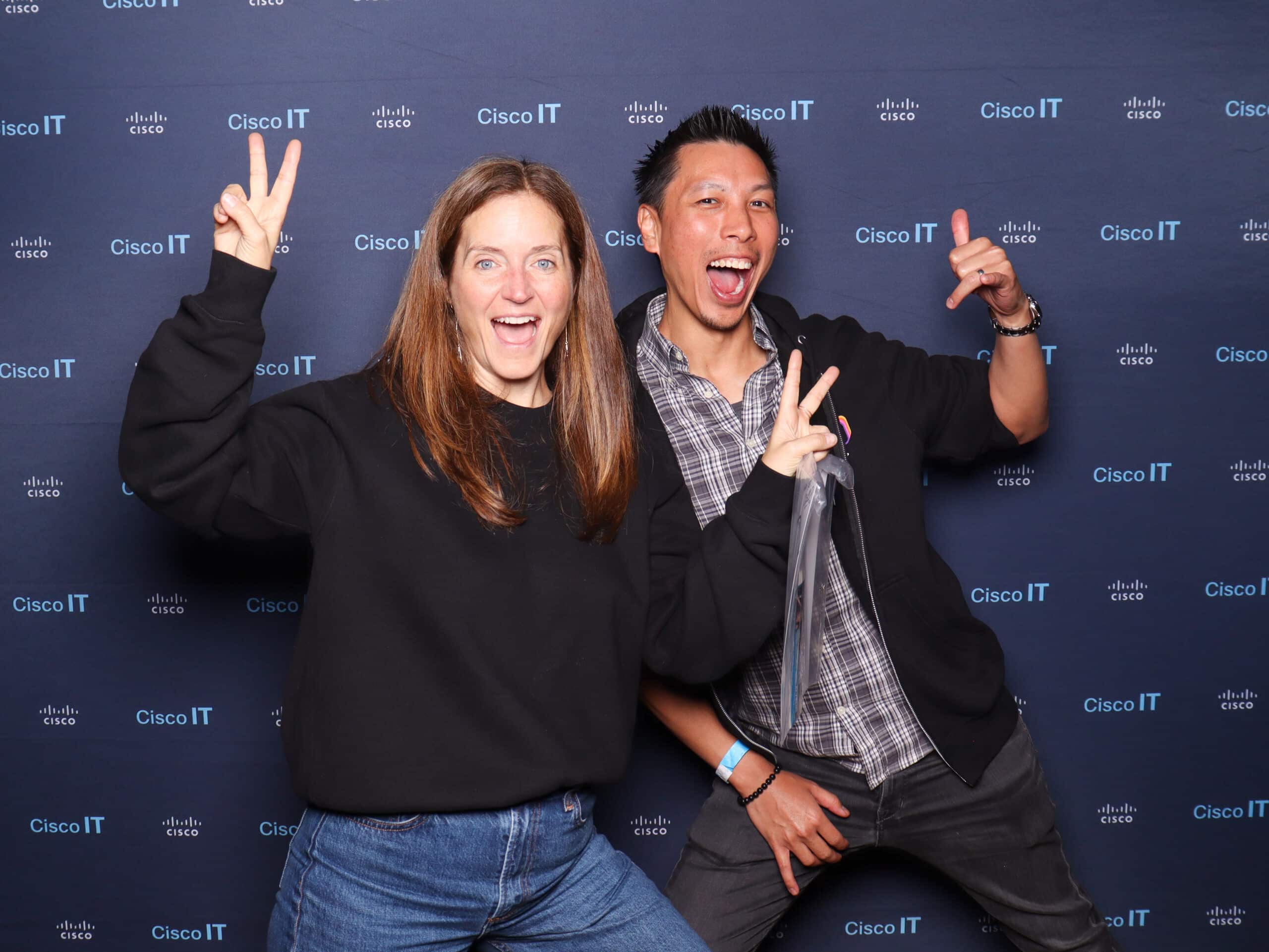 Branded Cisco IT photo booth with guests making peace signs, corporate event photo booth experience.