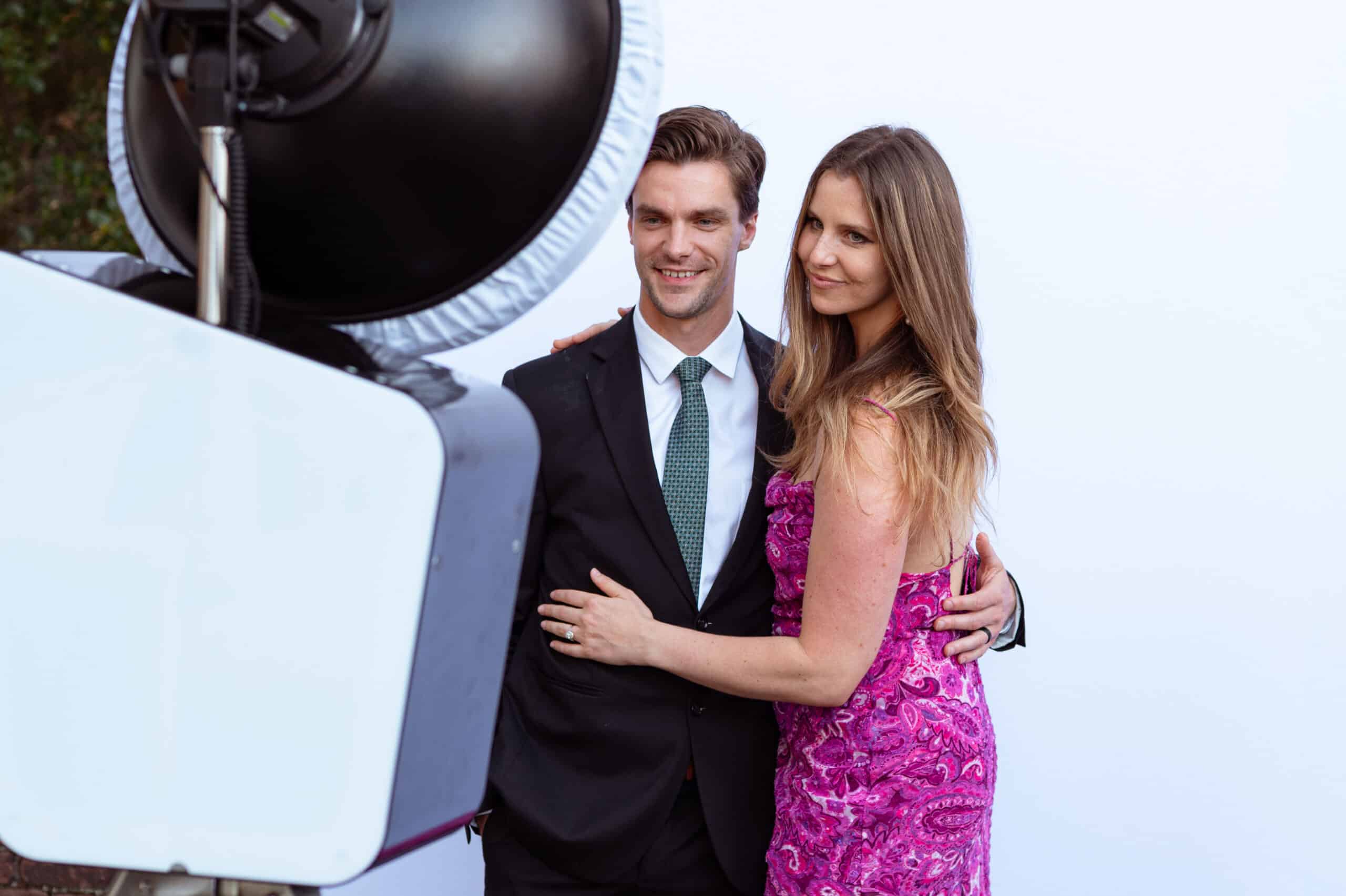 Couple taking a photo in front of a photo booth
