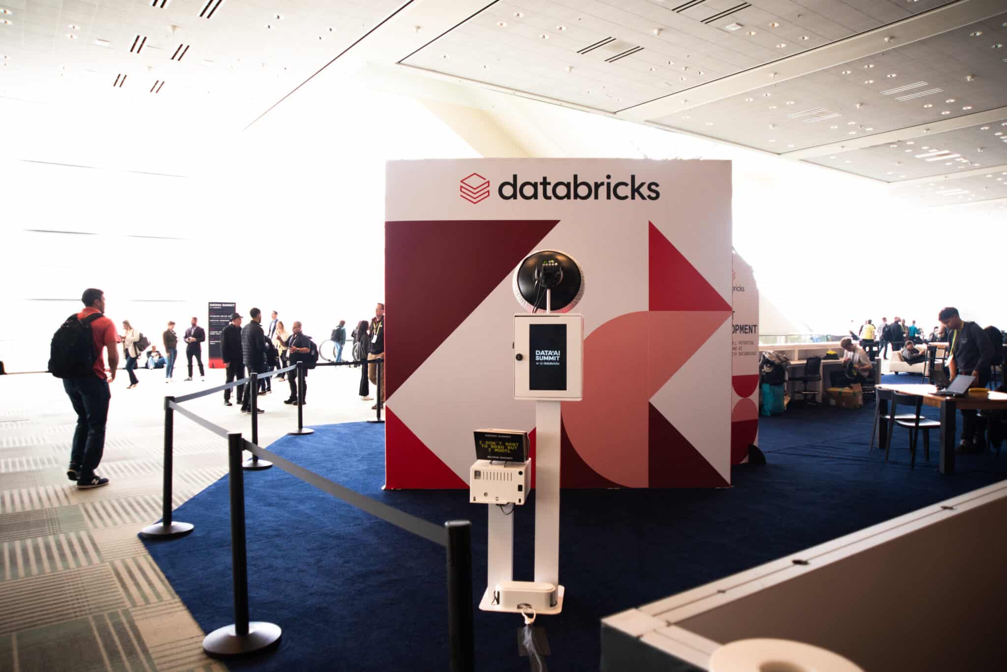 Branded photo booth at Databricks event with custom backdrop and instant print delivery.