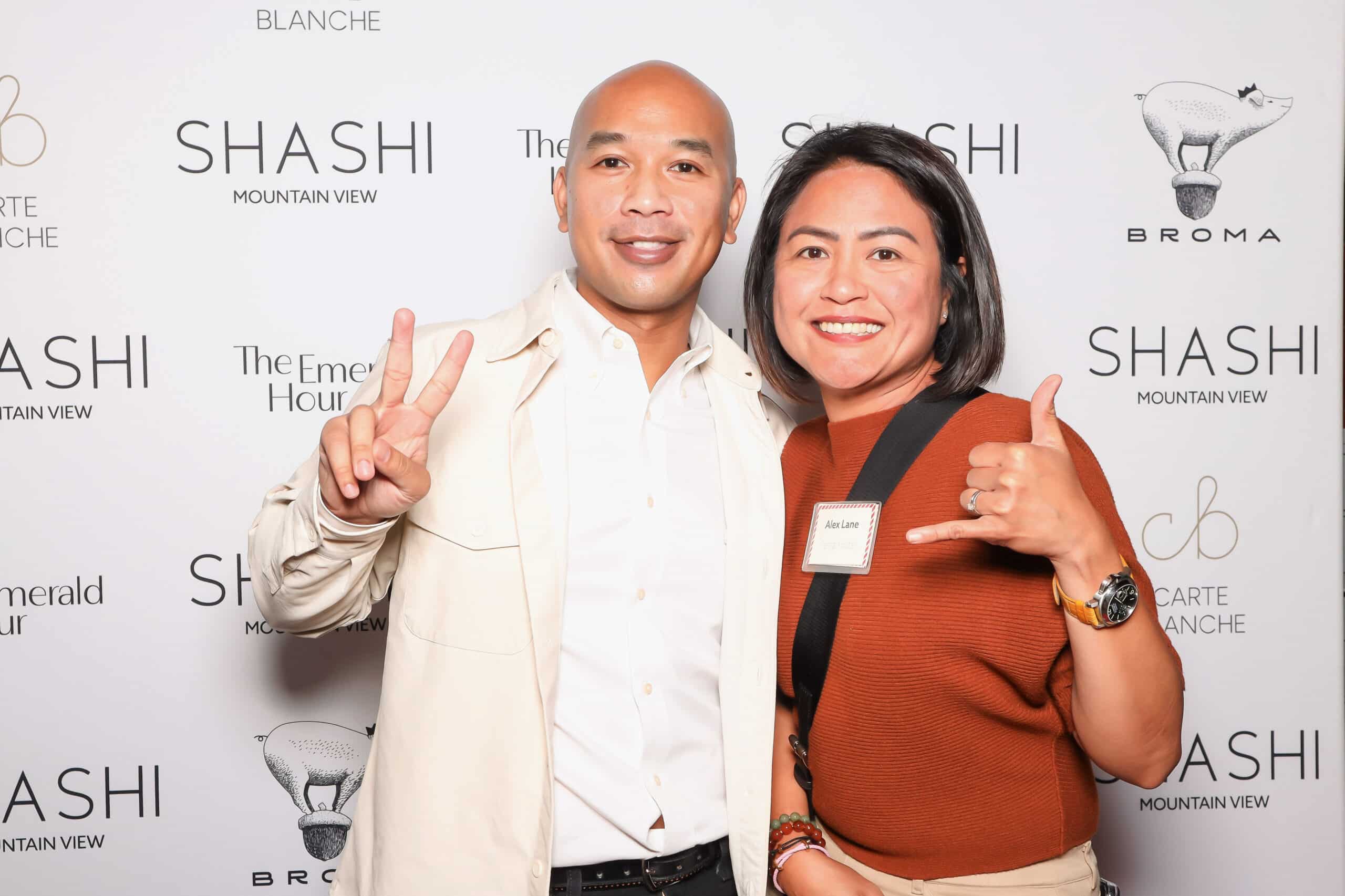 Branded corporate photo booth with guests posing and displaying custom branded overlay at Shashi Mountain