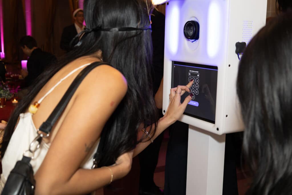 Guest interacting with Pop Life Photo Glam Booth for instant digital sharing