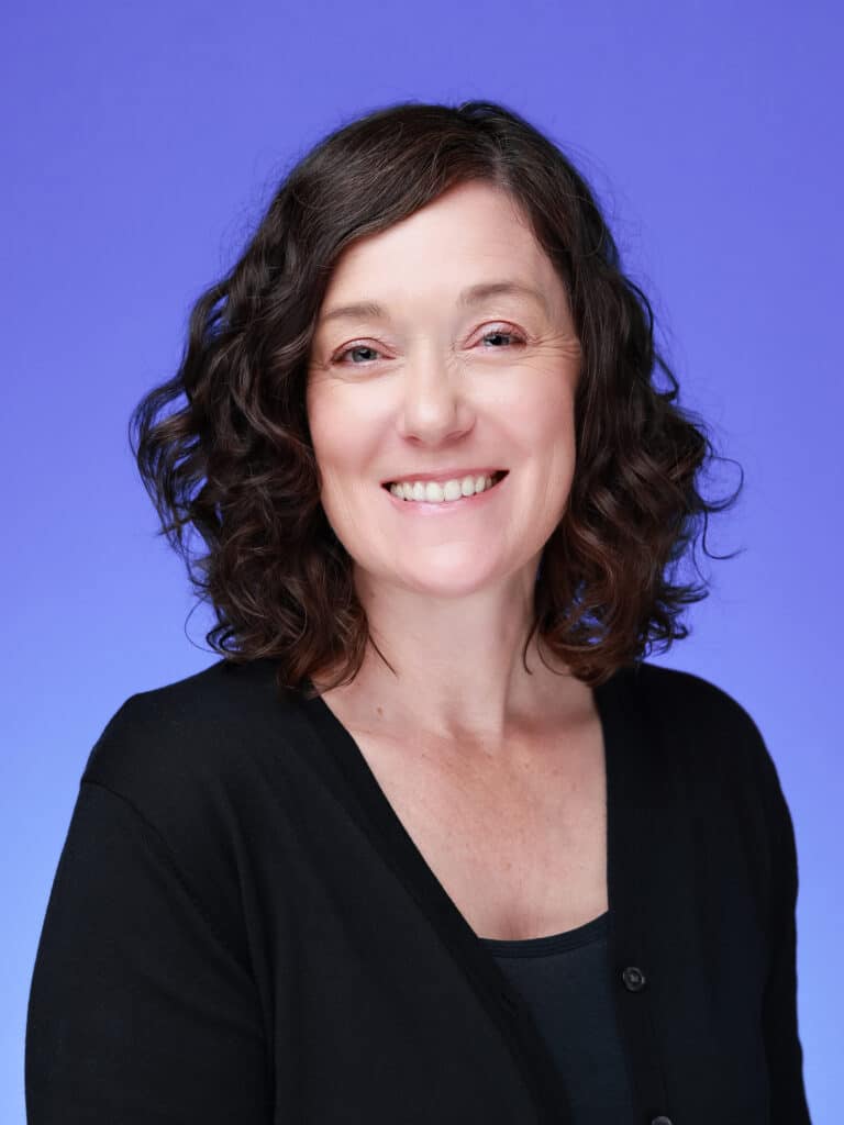 Pop Life Photo team member smiling in professional headshot, showcasing quality and exceptional service.