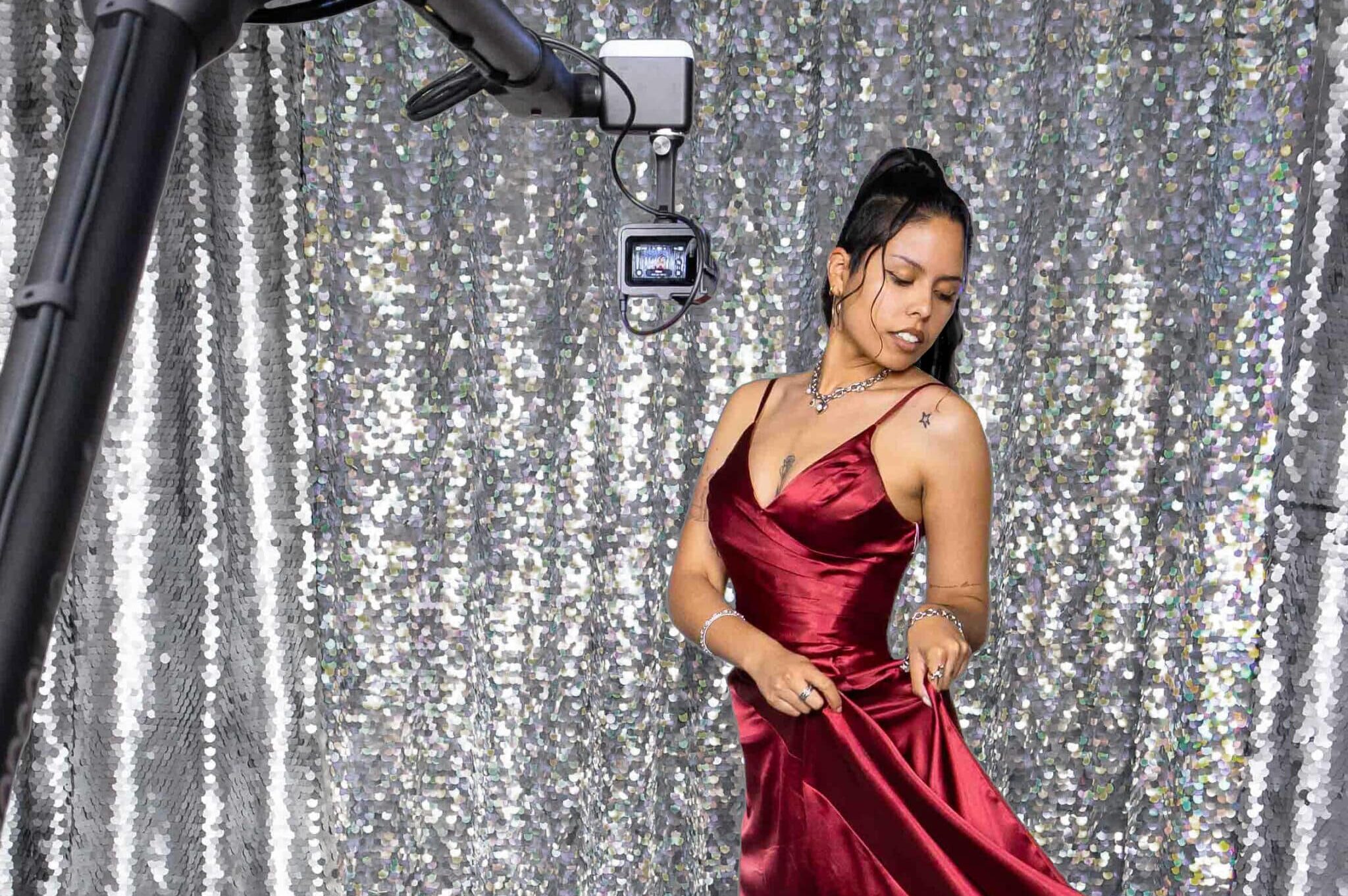 Woman wearing long red dress posing for a shot with a galmbot